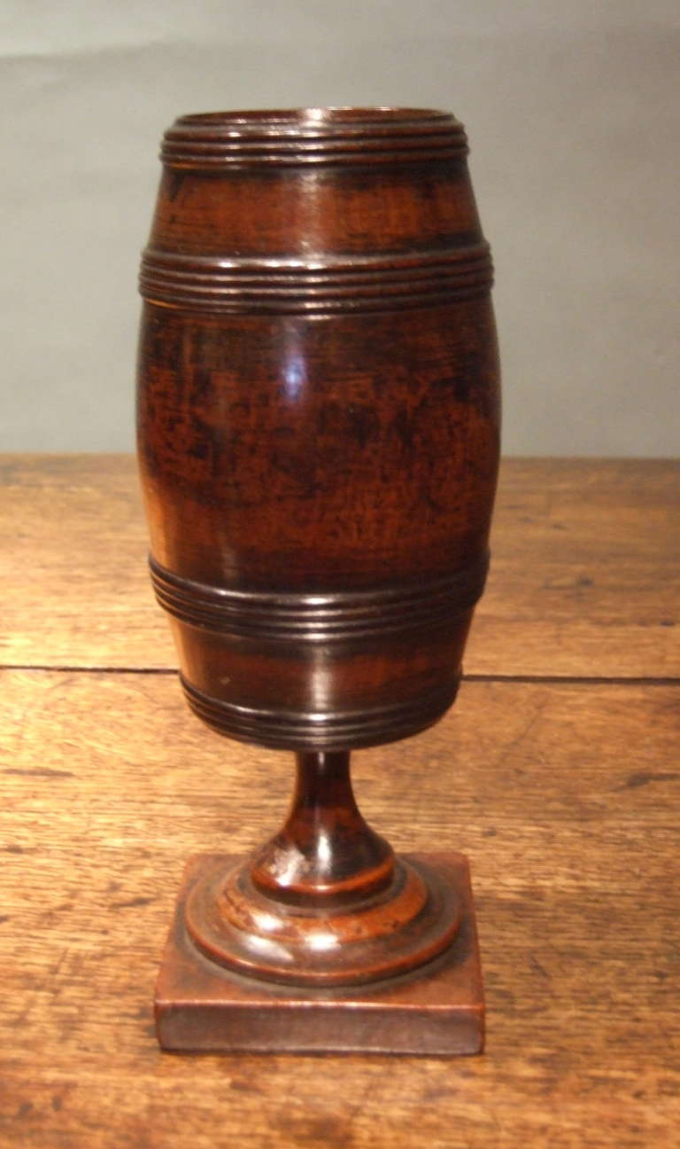 Fine George III period mahogany barrel form box on turned plinth base, the whole turned from a single block of mahogany and having lovely quadruple ringed band turnings and the whole having original richly patinated surface.

Treen