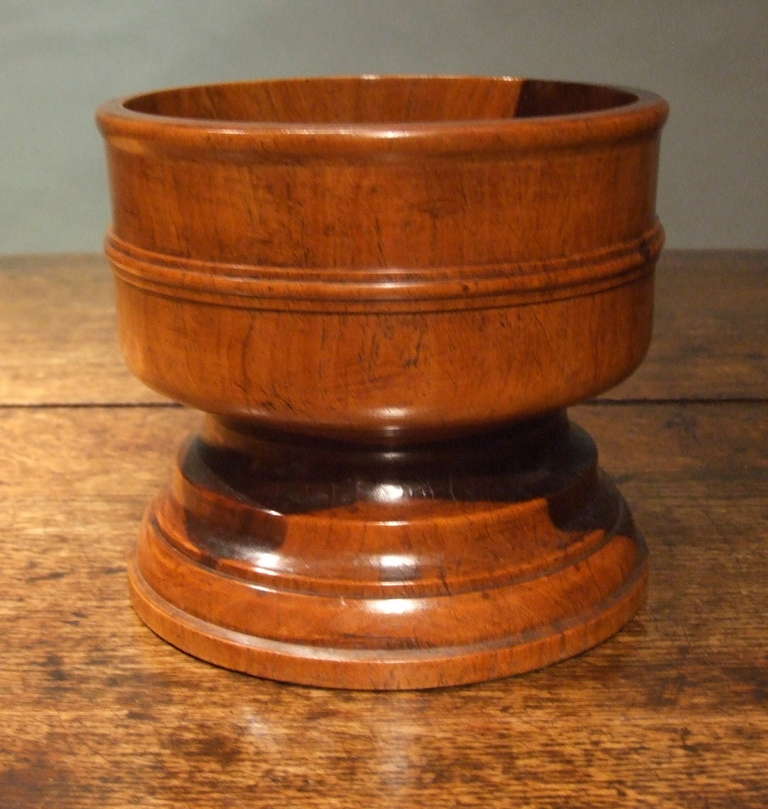 A fine mid 19th century English turned Lignum Vitae communal open salt.  The striking grain on this treen vessel shows the beauty of this timber and the great ability of the turner, which, combined with the impressive scale and excellent patina,