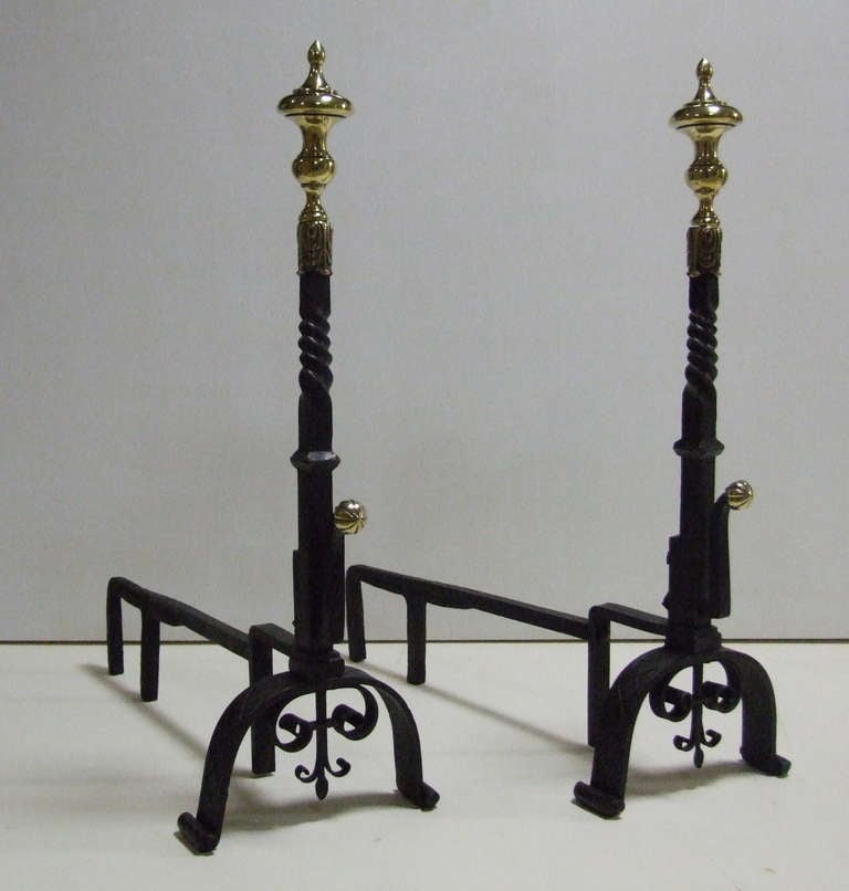 Impressive pair of 18th Century brass and iron andirons, the chased brass urn finials having foliate decoration, over barley twist shafts with gadrooned ball finials