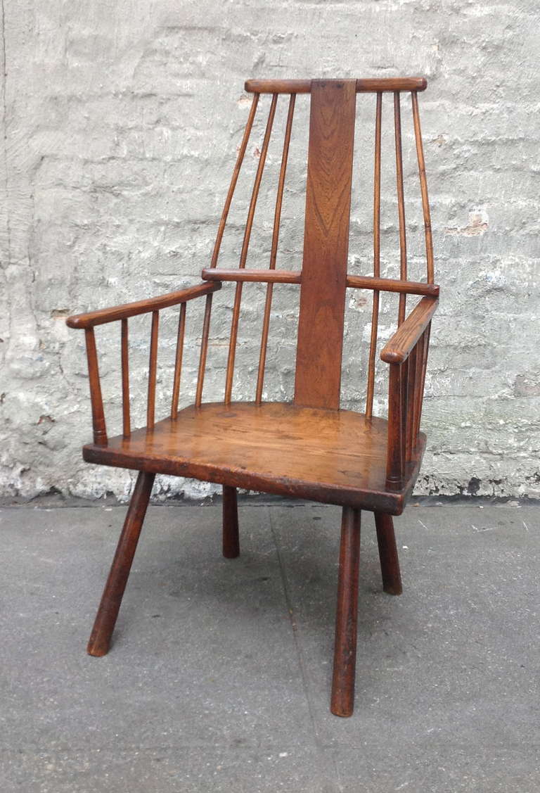 Very unusual Irish or West Country vernacular windsor comb back armchair, the simple bar crest over 