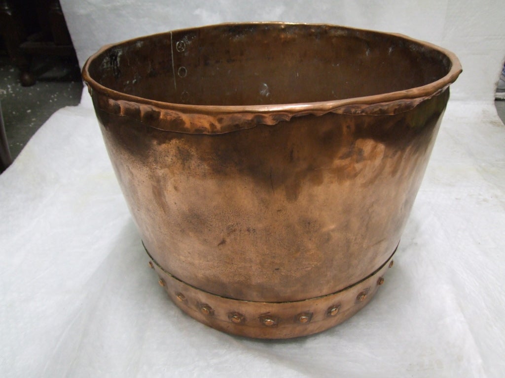 An English 19th century copper log bin with rolled rim and rivetted seams.  Hand-chisel marks to rivets.  Decorative and useful next to a fireplace for logs and kindling.

firewood, kindling, log holder