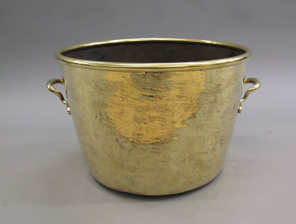 Fine Early 19th Century English hammered brass two handled pot with rolled lip, applied cast brass handles secured by copper rivets. the whole with beaten surface and good scale.

firewood, kindling, log holder