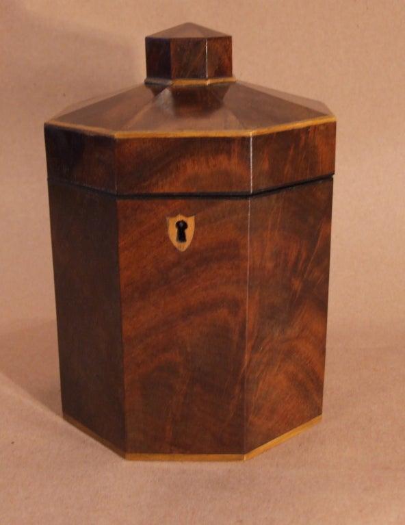 George III mahogany and boxwood tea caddy of octagonal pillar box form, having shield inlaid escutcheon and retaining old finish