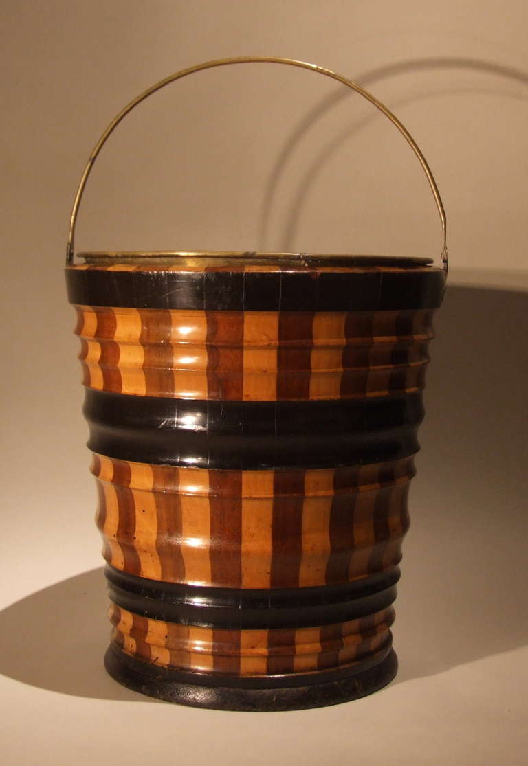 Fine mid-19th century Dutch coopered and turned bucket in mahogany and sycamore with ebonized turned bandings, original brass liner, the whole with pleasing color and patina.