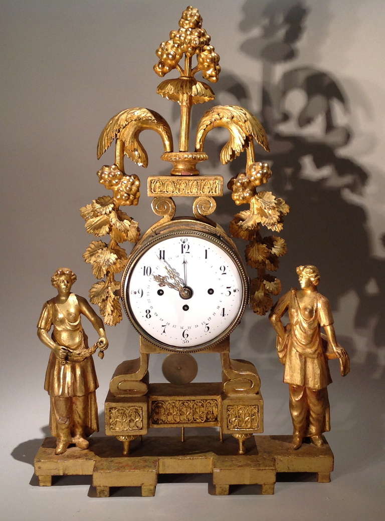 Very good early 19th century giltwood clock, the three train movement surrounded by carved and water gilt case with classical bacchanalian motifs and two robed figures, the movement with lovely chimes on the hour, half and quarter and having rare