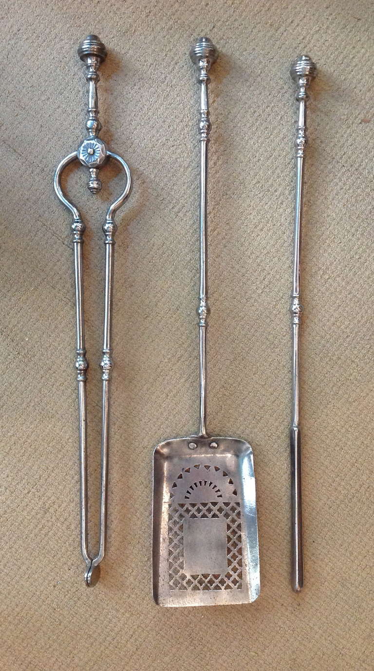 Fine quality set of three George III fire tools comprising a poker, tongs and shovel, the latter with rising sunburst pierced decoration, the handles with knob finials, the tongs in great working order.