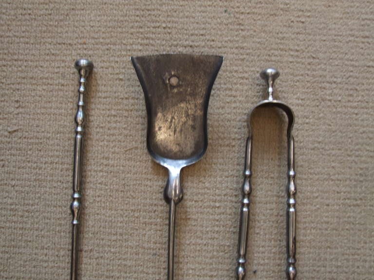 Good set of diminutive Queen Anne fire tools having ringed button finials, double balustrade turned shafts, good gun metal finish.