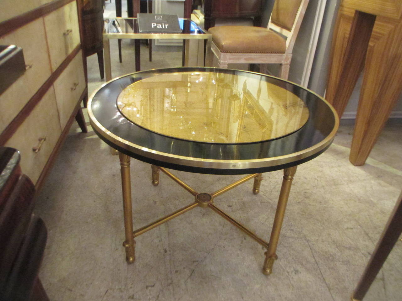 Circular cocktail table with gilt glass top