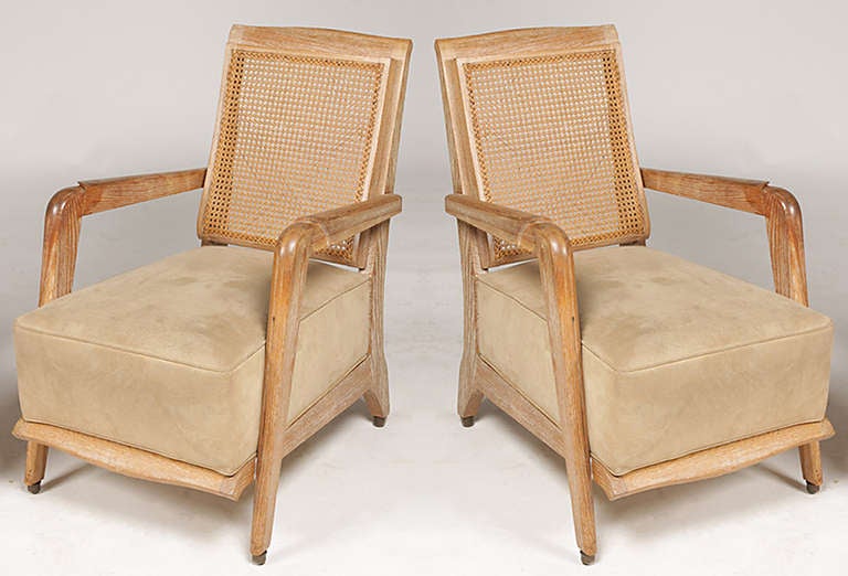 A very unusual pair of French 1940s cerused oak, caned armchairs.