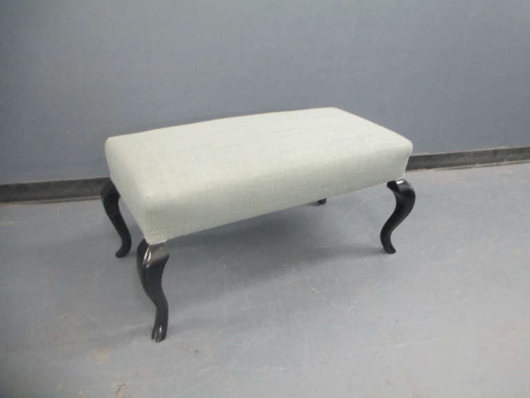 Whimsical Hollywood Regency bench on stylized ebonized legs.