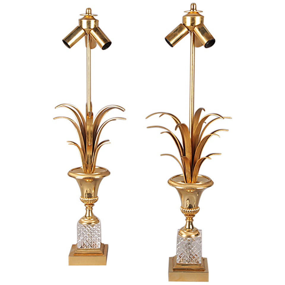 A pair of brass and crystal lamps attributed to Maison Charles.