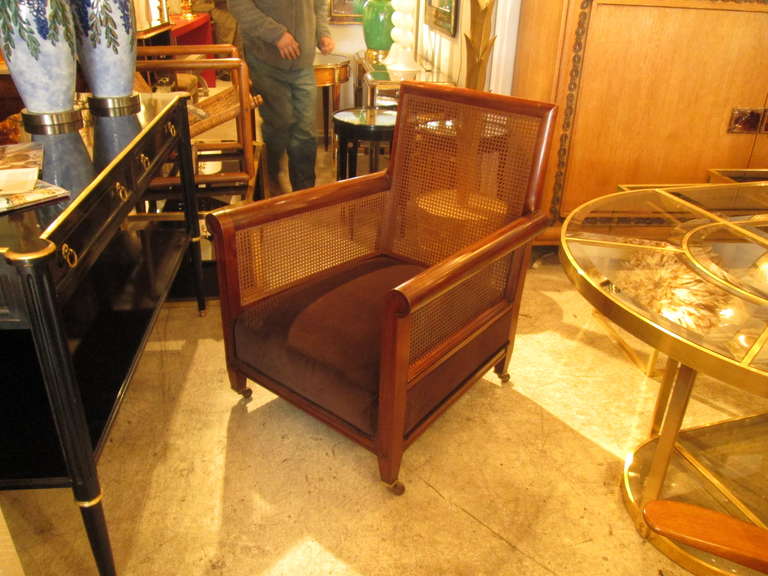 A rare pair of oversized Edwardian rosewood caned library chairs on castor.