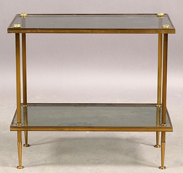 A Pair of two-tiered brass and smoked glass tables