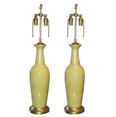 A pair of yellow porcelain lamps