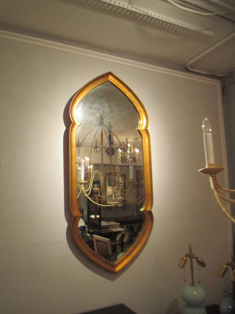 Gilt wood mirror in the Gothic manner.