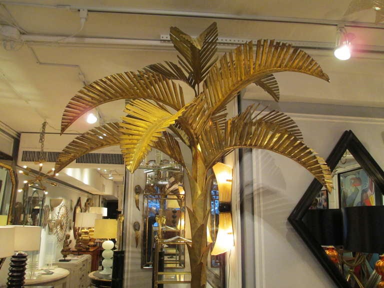 Exquisite 8 feet tall gilt metal palm tree featuring removable fronds with the base in the form of a brass-bound wooden bucket

The base's diameter is 15