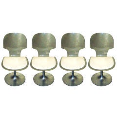 A Set of Four Sculptural Lucite Chairs on Chrome Base