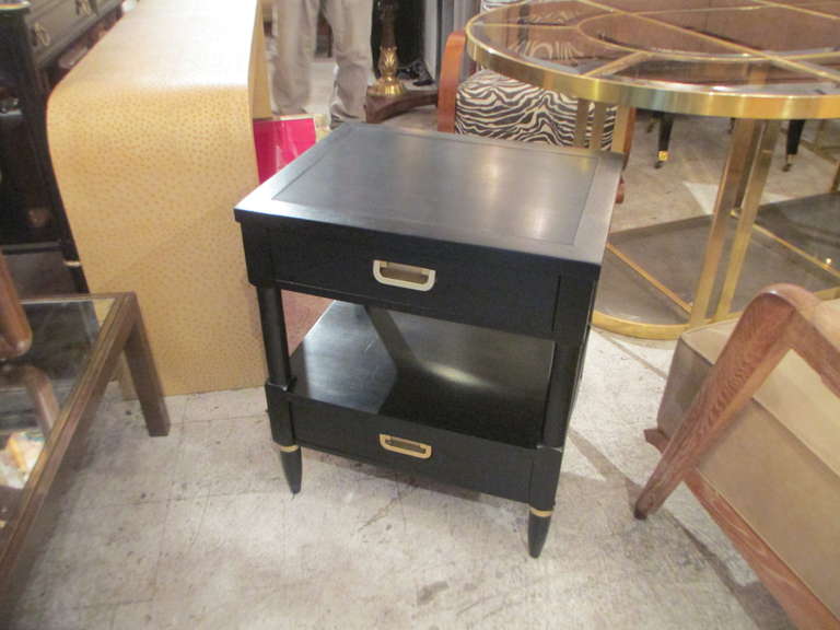 A pair of ebonized two-tiered night stands.