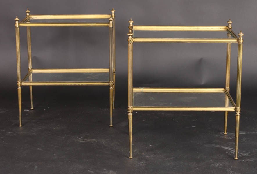 A pair of French bronze two tiered end tables
