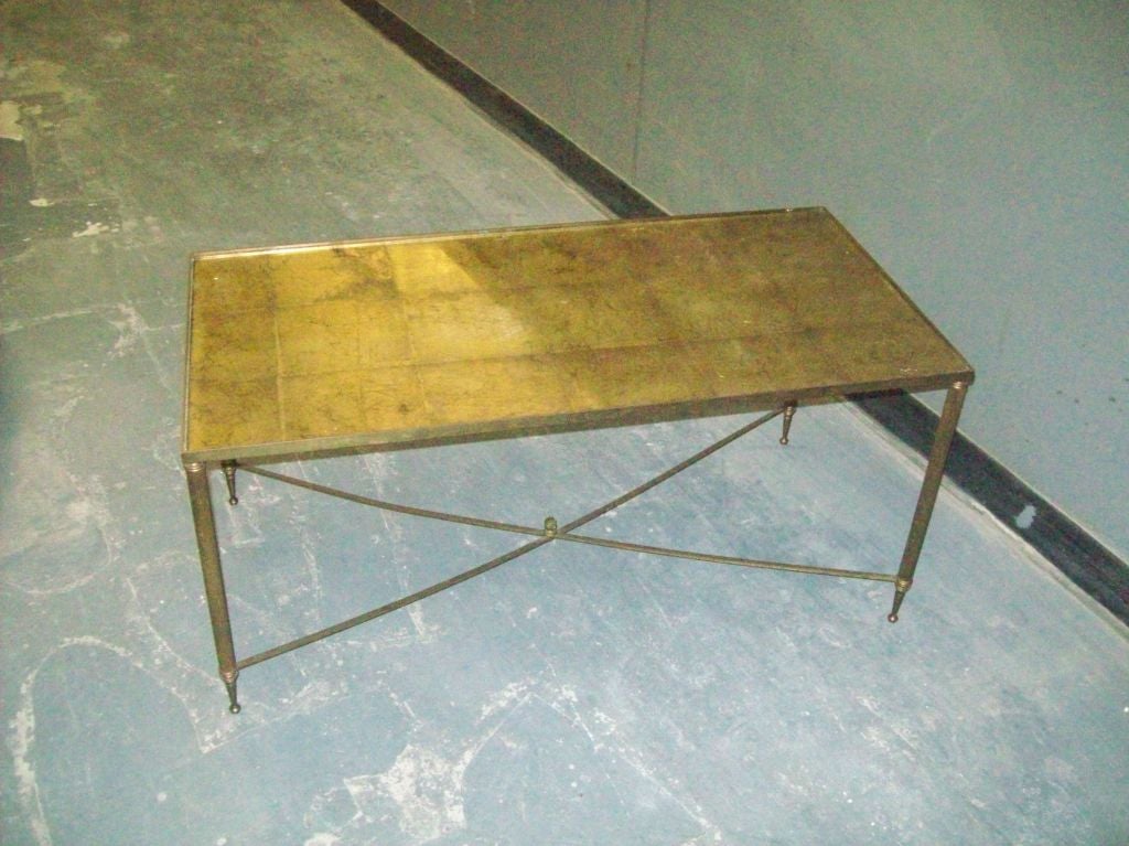 French rectangular brass coffee table with gold-leafed glass top.