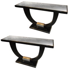 A Pair Of Art Deco Style Ebonized And Silver leaf console tables