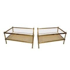 A pair of two-tiered bronze and parchment coffee/cocktail  tables
