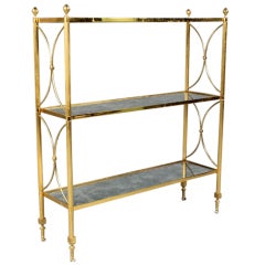 Exquisite Regency style brass etagere with distressed mirror