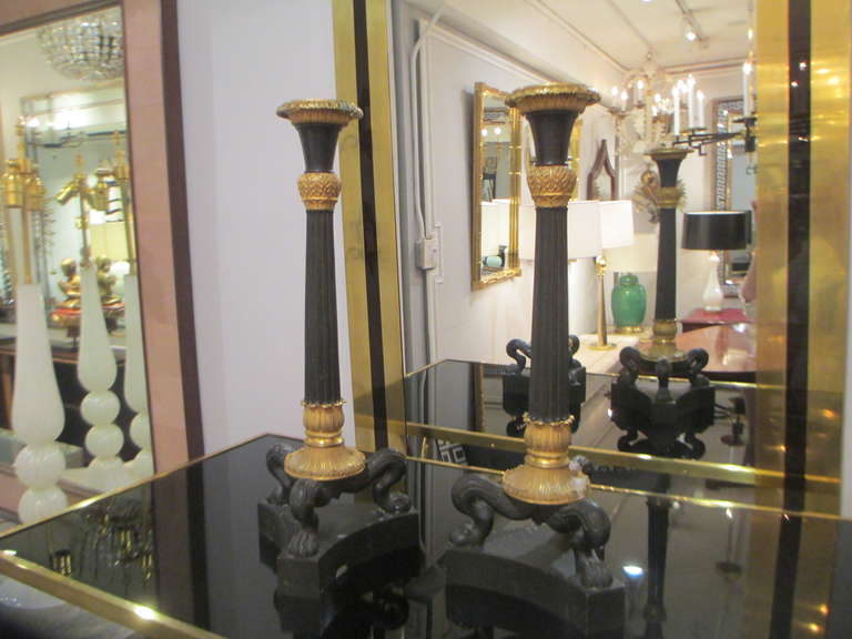 A pair of bronze Regency candlesticks.