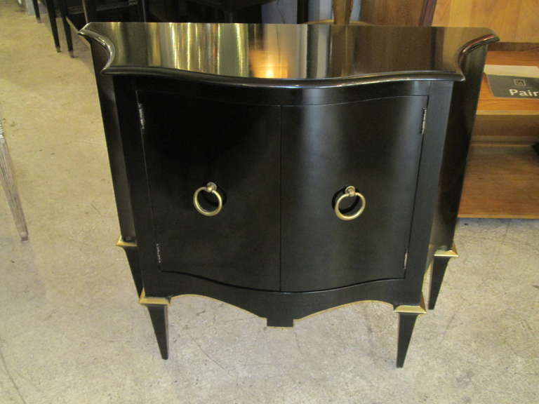 A pair of Mid-Century Modern ebonized commodes in the Parzinger manner.