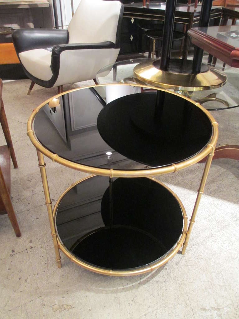 A pair of gilt bronze faux bamboo tables with smoked glass tops.