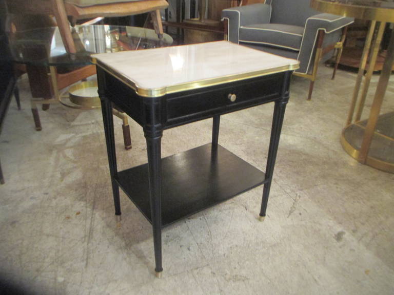 Pair of Louis XVI style ebonized, bronzed trimmed marble-top end tables.
France, circa 1940s-1950s, with pullout drawer, possibly by Maison Jansen.