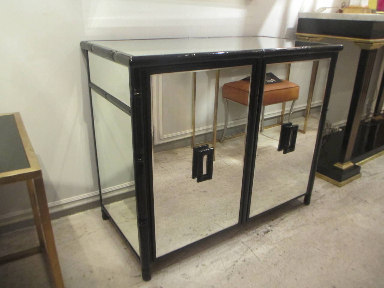 Mirrored two -door cabinet with ebonized faux bamboo frame