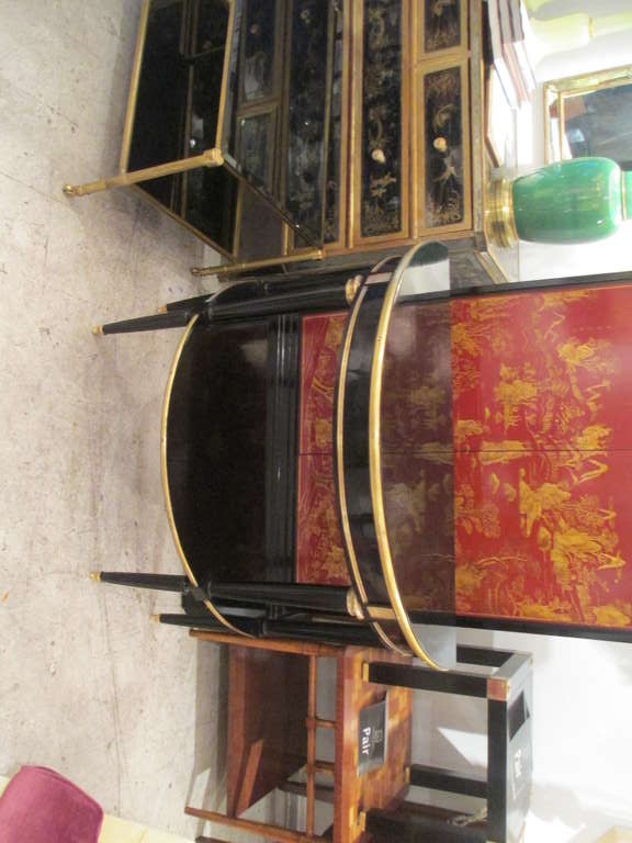 A Pair Of Bronze And Brass Mounted Ebonized Demilune Consoles