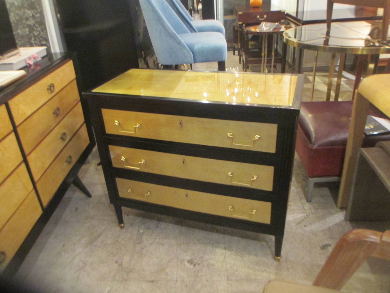 A pair of ebonized and gold leafed Directoire style commodes.