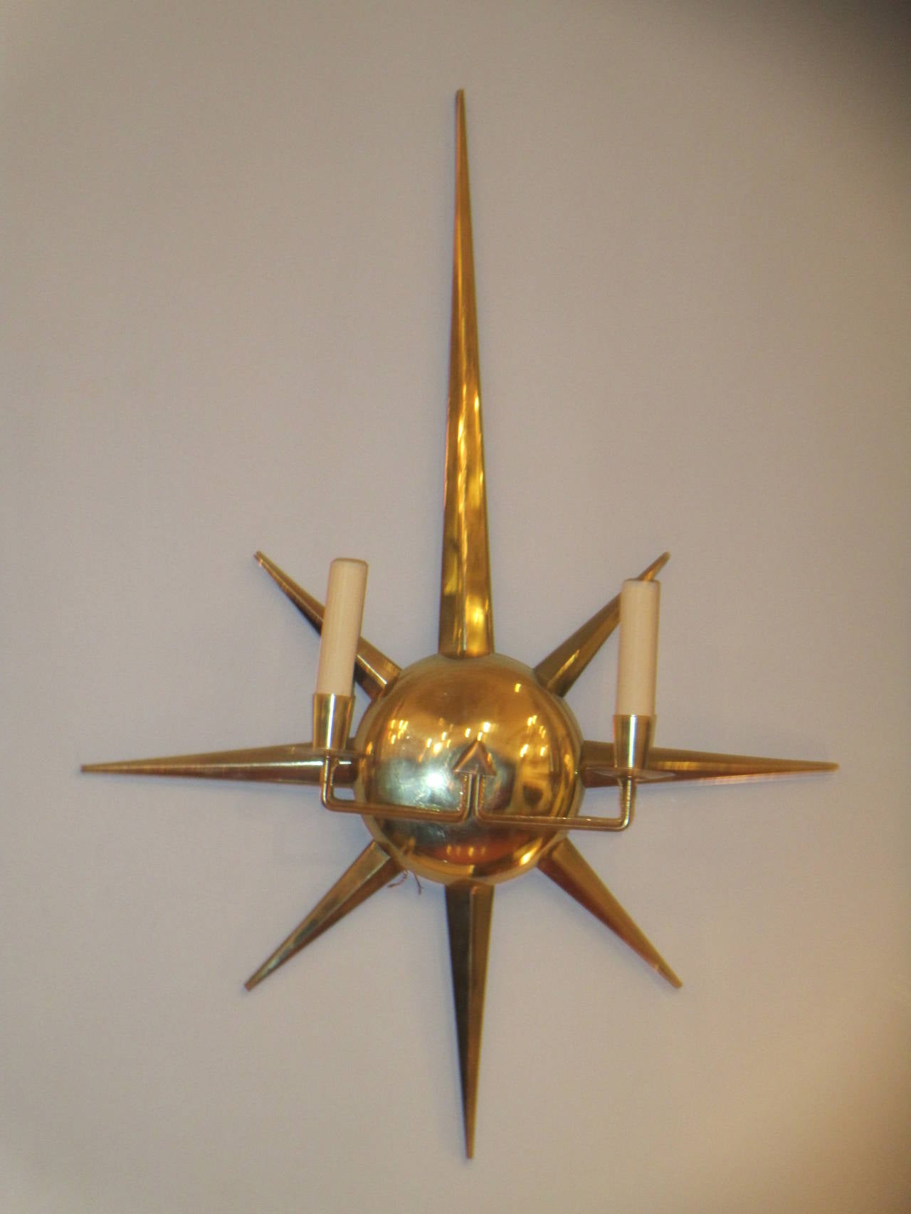 A pair of Mid-Century Italian starburst brass sconces.