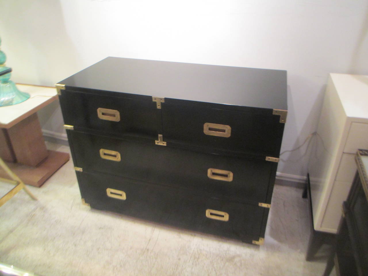 A pair of ebonized Campaign chests with applied brass and three pull-out drawers, chests can also be sold separately