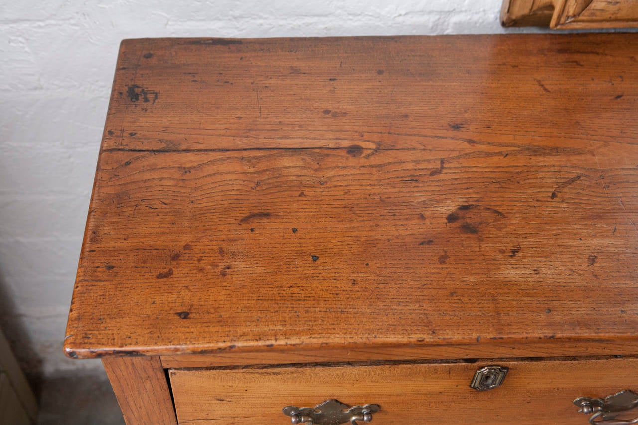 This wonderful Elm Dresser base is a beautifully crafted piece made with old growth wood and Georgian period details. The dresser base can be used as a side board, console table or buffet in a variety of settings. The piece has three drawers with