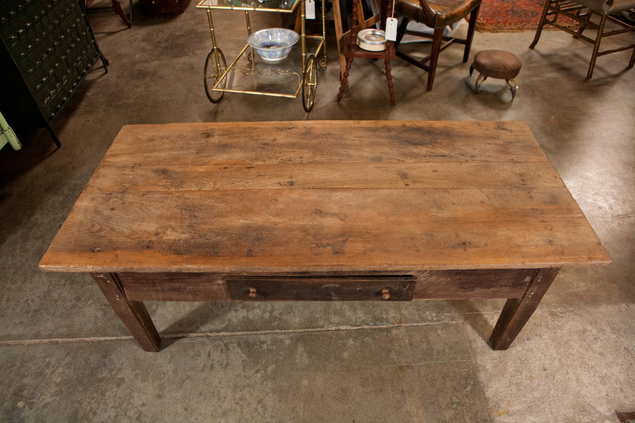 This french country wood coffee table with one drawer is a great piece with strong character and nice lines. The tapered legs create an subtle curve in the squared off lines of the design. Made with old growth country wood and solid construction