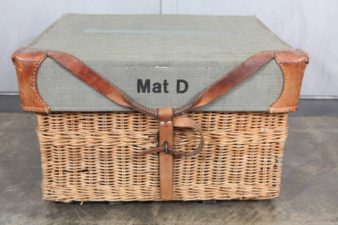 This rare example of a Swiss military wicker basket has a number of interesting features. From the condition and style the baskets appear to be issued during world war II, used to store and haul food. The basket has a sun faded green corduroy fabric