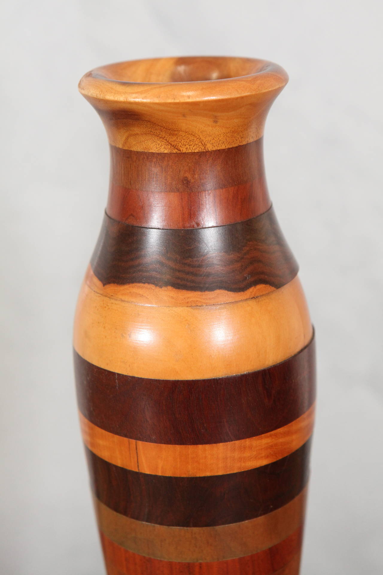 These vases are beautifully crafted pieces from New England. Note the simplicity and elegance of their shape which indicates they were made by a craftsman prior to mid-19th century. The vases are made of 15 different kinds of wood listed in hand