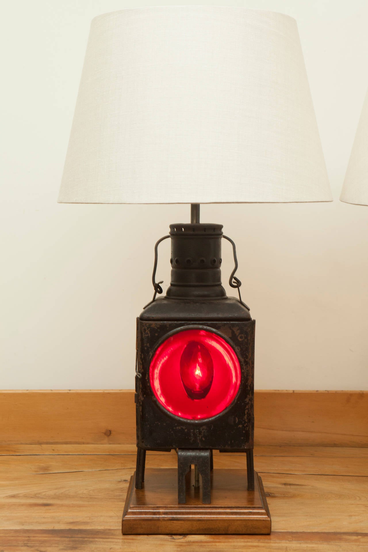 We had a pair of these lamps, but have sold one so we are offering the second on its own.  This signal train lantern was converted into an electric lamps with two light sources; the red lens light from the body of the lantern and the conventional