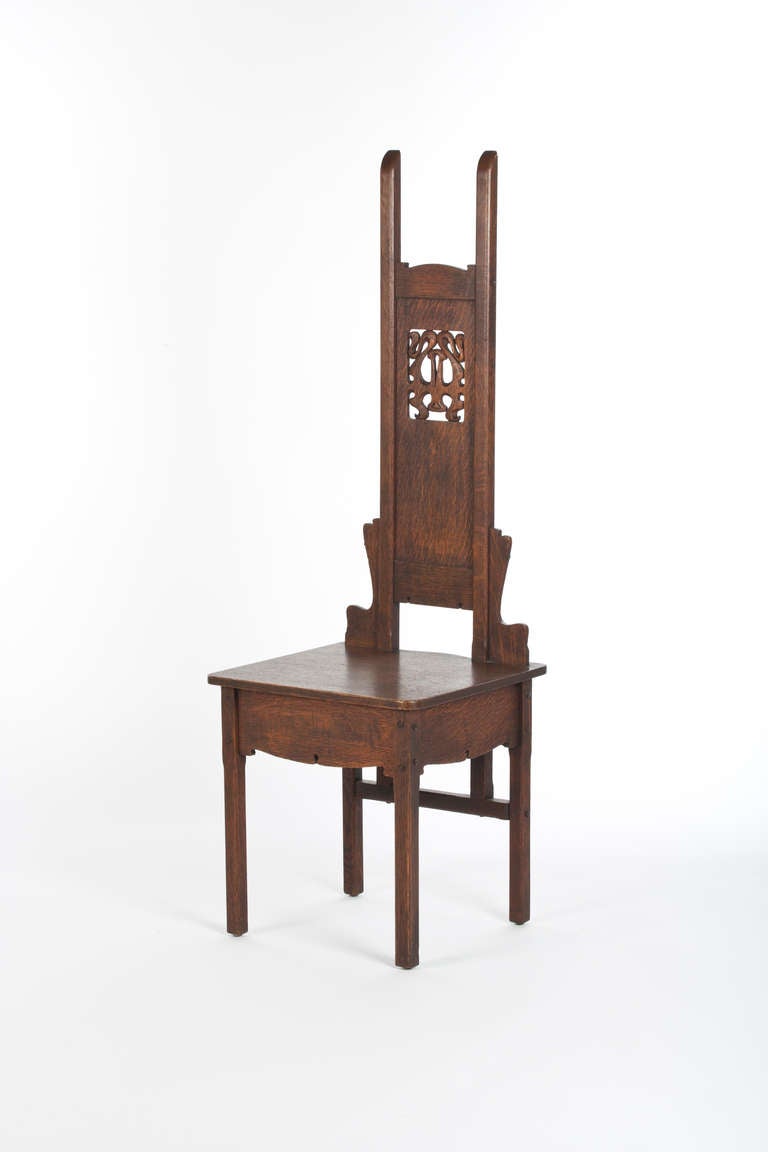 Charles Rohlfs hall chair, high-back form with carved and pierced design at back with organic motif on a slab seat, signed and dated 1901, refinished