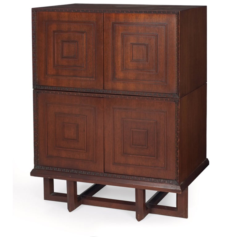 Stacking Cabinets by Frank Lloyd Wright. Manufactured by Heritage Henredon. Two cabinets on a cradle base, each has two doors and one adjustable shelf. Talesin design at edges. Signed with red monogram. Numbered 2005