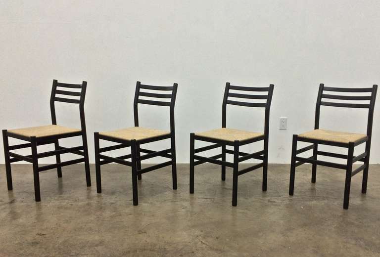 Suite of 6 modernist dining chairs, circa 1970.  Made in Italy.  Wood frames, rush seats.  Very good condition.