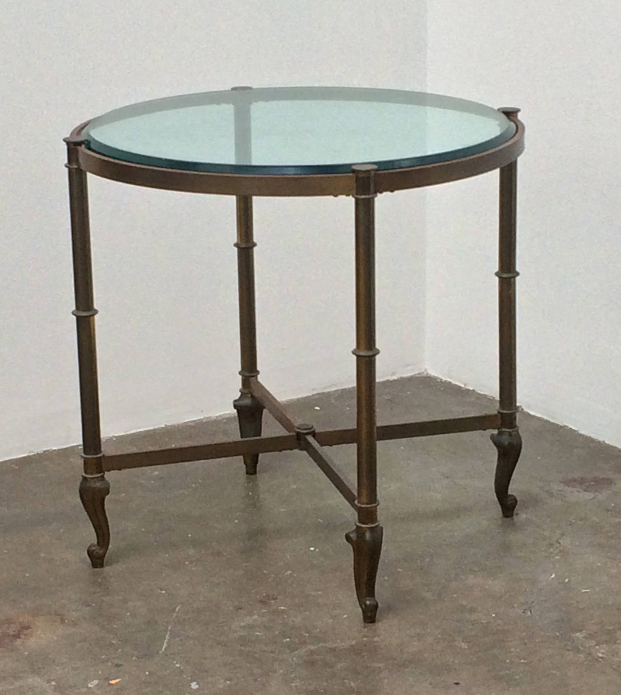 Circular table in the manner of La Barge
Circa 1950
brass, sloped, bevelled glass top
25.5 in diameter
24 inches high
Very good condition