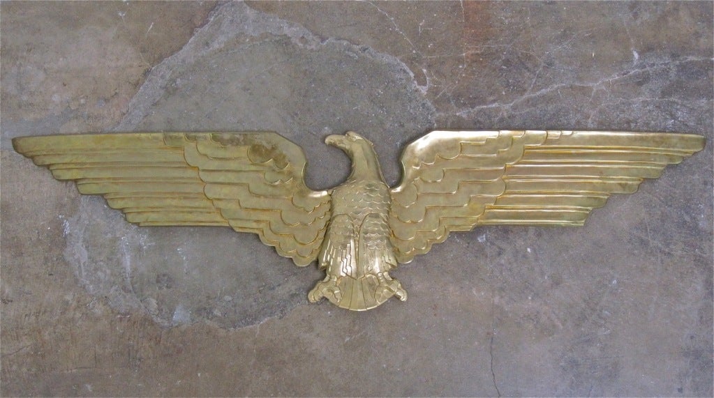 Art Deco brass-plated cast metal American eagle in three separate pieces, circa 1935. Probably cast as an architectural adornment. Very heavy, screws en verso make for easy mounting. From a Bel Air estate.