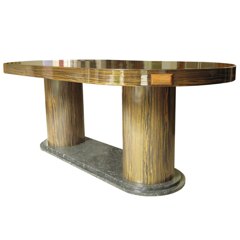 French Art Deco Dining Table from the Loire Valley, France. Circa 1930s, Marble base, macassar ebony pedestals and 78 inch top.  Two approximately 25-inch extension leaves. Fully extended the table measures approximately 128 inches. It has been