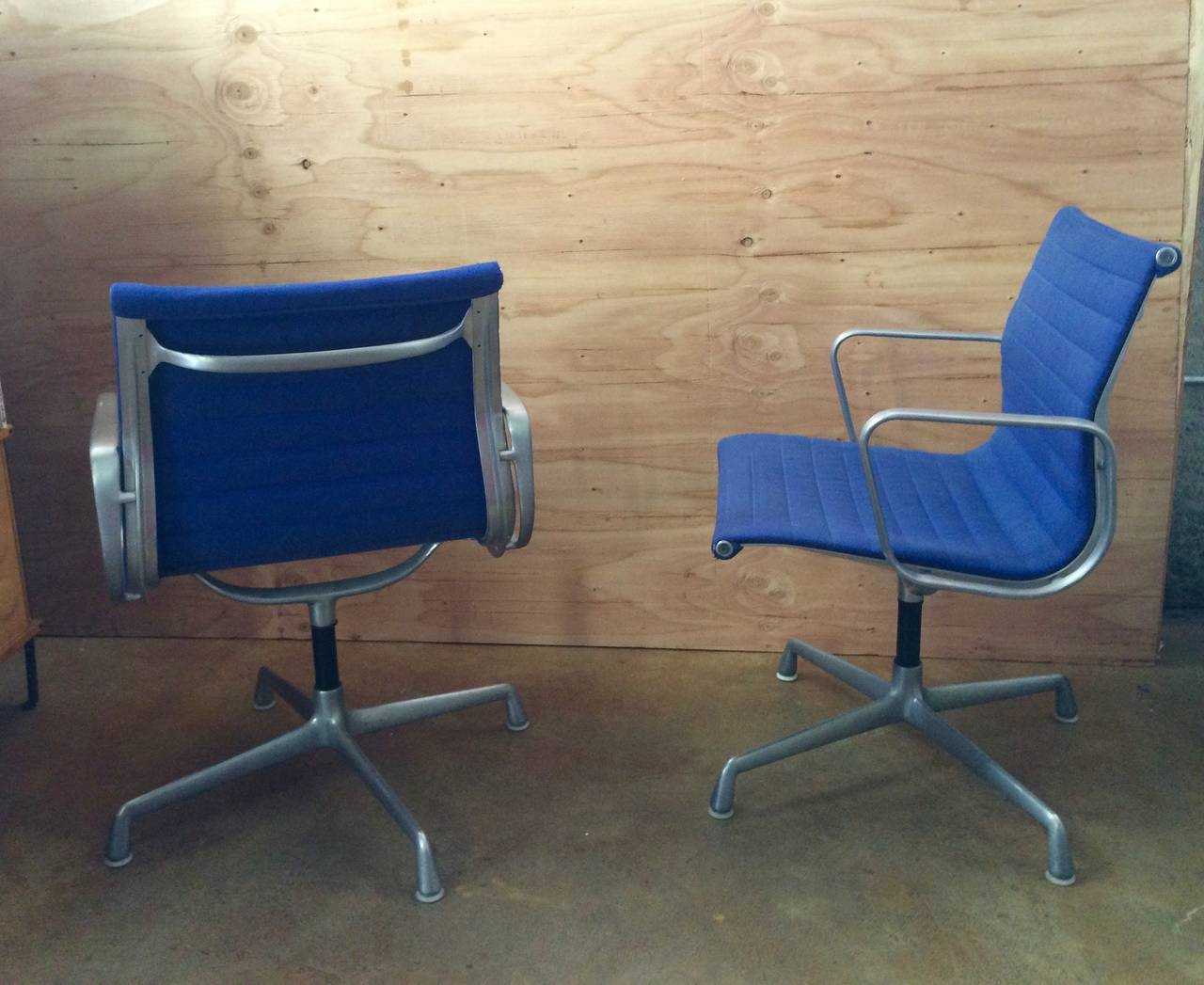 Charles Eames
Pair of Aluminum Group Chairs
Designed 1958, manufactured later
Aluminum frame, blue wool upholstery
Plastic removed from aluminum, one minor scuff on arm, one minor tear in upholstery at corner, otherwise fresh and in good