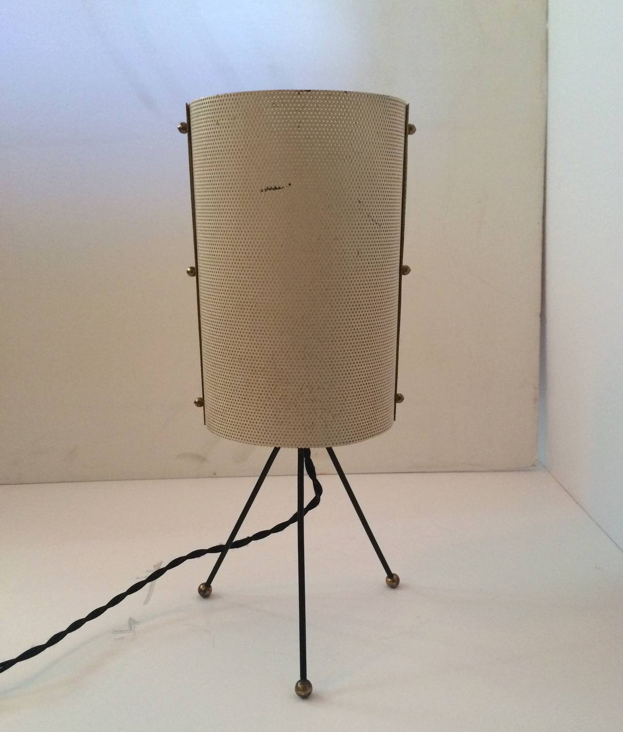 Table Lamp (In the style of Mathieu Mategot)
Circa 1950s
Tripod metal base, brass ball feet, perforated, cylindrical metal shade
Excellent original condition, new electrical wire and plug
