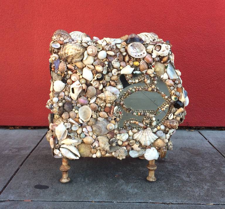 California Folk Art Grotto Table
circa 1940
Seashells and mirrors encrusted over a cathedral style radio with legs made from spools.
22 x 21 x 15 inches
Discovered in Carmel, CA
Excellent condition

More a sculpture than a functional piece of